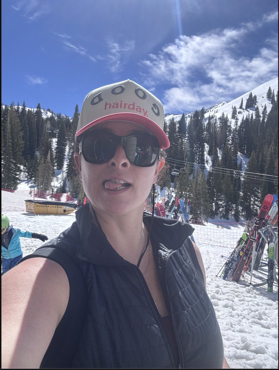 M. Spring in a cap and sunglasses on a sunny ski day